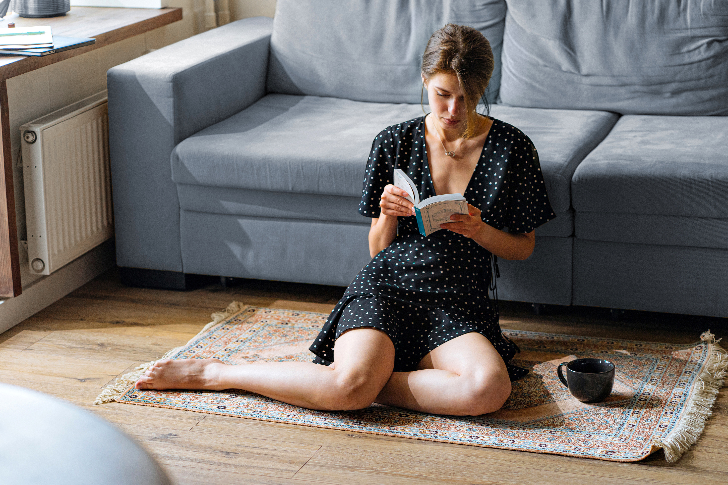 Woman reading book in cozy home setting